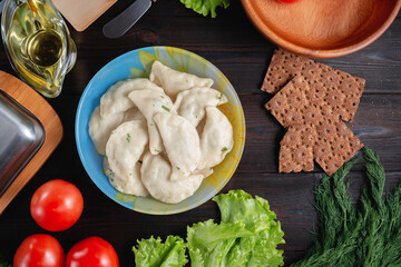 homemade natural farm dumplings and dumplings on the table with vegetables and herbs.