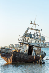 An old rusty ship rotting on the seashore. Shchelkino town, Crimea