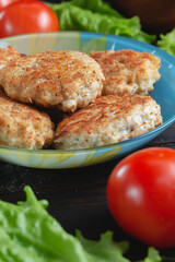 homemade natural farm cutlets on the table with vegetables and herbs.