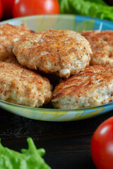 homemade natural farm cutlets on the table with vegetables and herbs.