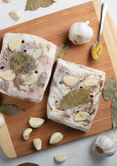 Freezer lard on a cutting board with garlic, mustard, and bay leaf