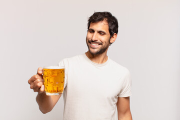 young handsome indian man happy expression and holding a beer