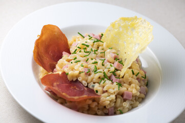 Pastasotto recipe with shells and ham, ham and cheese tiles, High quality photo