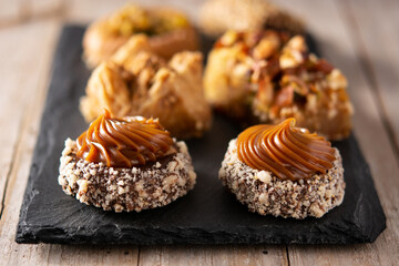 Assortment of Ramadan dessert baklava on wooden table. Traditional arabic sweets