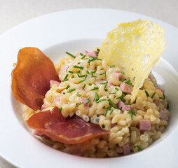 Pastasotto recipe with shells and ham, ham and cheese tiles, High quality photo