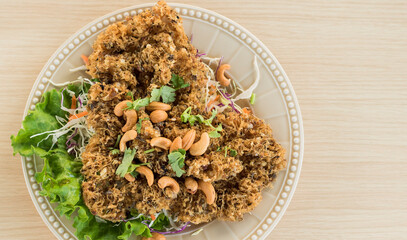 The top view reiterates the full-bodied catfish in the plates on the Thai dining table.