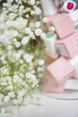 Pink jars folded into a jar with a sprig and white flowers