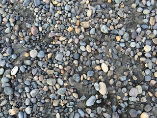 Background of sea stones in the sand.