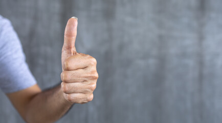 young man hand is displaying a thumbs up with copy space