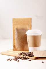 Take away paper cup of coffee and blank coffee packs