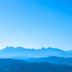 Blue surreal mountains against the backdrop of a cyan sky, fantastic fairytale mountain landscape