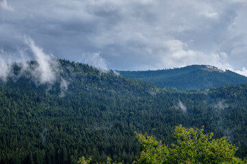 View onto the wooded mountains of the Bavarian Forest around  Frahels - Lam with grey clouds ofter some summer rain. Seen in Germany in August.