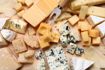 Cheese plate on wooden board, top view