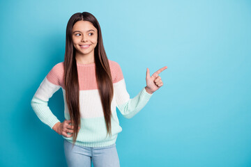 Fototapeta premium Portrait of cheerful pupil look indicate finger empty space proposition isolated on blue color background