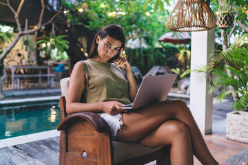 Serious young businesswoman working outside