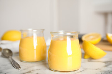 Delicious lemon curd on white marble table