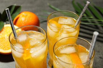 Delicious orange soda water in glasses, closeup