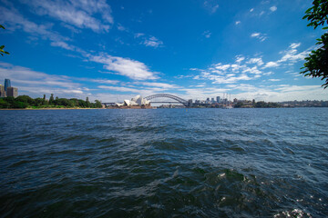 Sydney Harbour forshore viewed from the Gardens in NSW Australia on a nice sunny and partly cloudy Morning blue skies