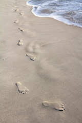 Footprints on the sand.Imprint, engrave on sand.Barefoot.White sand background.Summer, holiday and vacation.