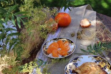 Naklejka na ściany i meble A snack with fruit pie and coffee in the garden. 