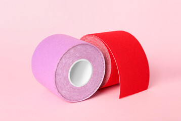 Bright kinesio tape in rolls on pink background