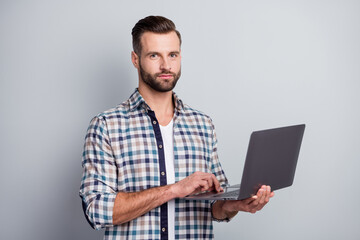 Photo portrait of serious confident freelancer programmer working on start-up project isolated on grey color background