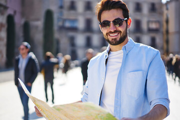 Happy man navigating with map