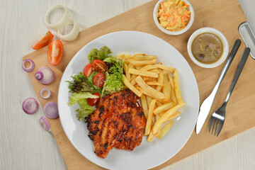 delicious plate of western food chicken chop with fries and salad