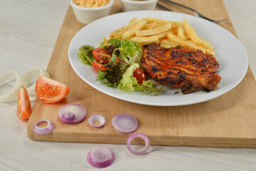 delicious plate of western food chicken chop with fries and salad