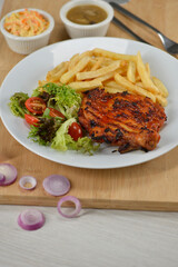 delicious plate of western food chicken chop with fries and salad