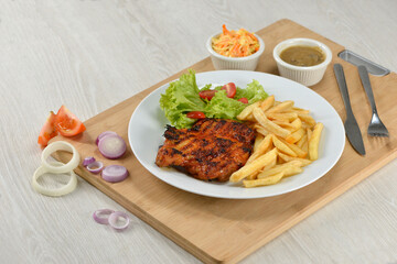 delicious plate of western food chicken chop with fries and salad