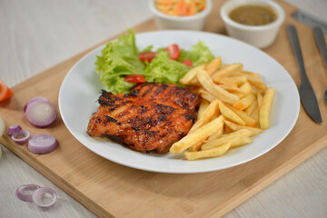 delicious plate of western food chicken chop with fries and salad