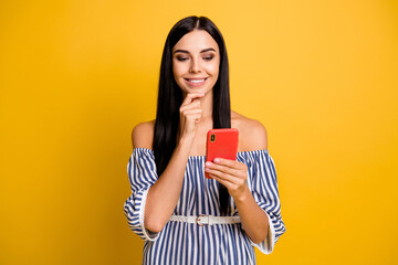 Photo of sweet dreamy young woman dressed off-shoulders dress holding modern gadget arm chin isolated yellow color background