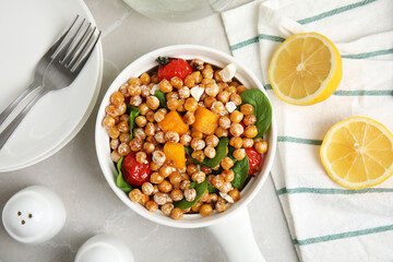Delicious fresh chickpea salad served on light grey marble table, flat lay