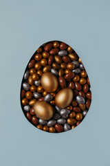 Easter concept with golden eggs flat lay sharp on blue background