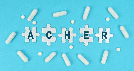 On a blue background, there are pills and puzzles with the inscription - ACHER