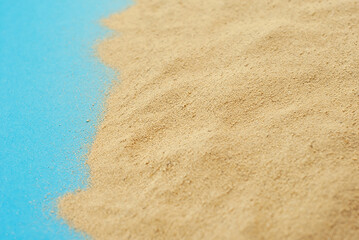 Artificial beach made of cardboard and sand. Stylized sea. The concept of rest, sea and vacation.