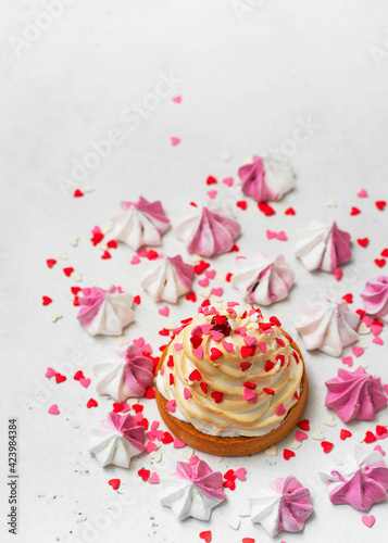 Mother's day holiday brunch with cupcake craem and pink flowers on white background