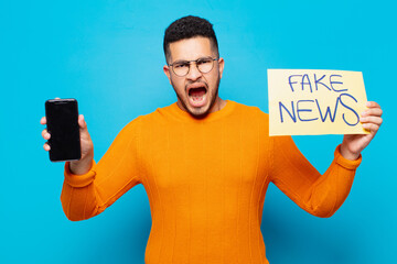 young hispanic man angry expression fake news concept