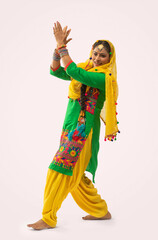 A Giddha dancer performing a dance step.	