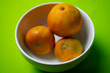 Clementine orange in white bowl