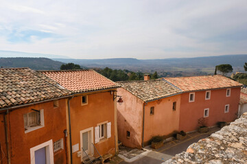 Old houses painted with ocher. Roussillon tourist village. Provence. France.