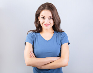 Obraz premium Beautiful young casual cute smiling woman thinking with folded arms. Closeup portrait with empty copy space