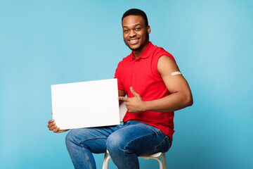Vaccinated Man Holding Poster For Coronavirus Vaccination Ad, Blue Background