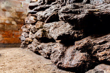 Dry charcoal pile stacked in basement