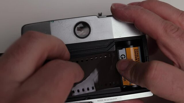 Loading a negative film into a camera - studio photography