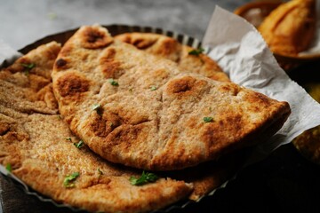 Wholegrain wheat Naan -Indian flat bread served with chicken korma, selective focus