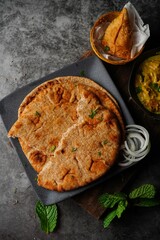 Wholegrain wheat Naan -Indian flat bread served with chicken korma, selective focus