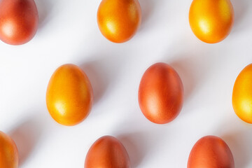 Pattern of golden eggs on white background. Happy Easter.