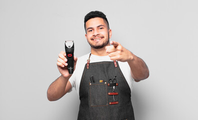 young hispanic man pointing or showing. barber concept